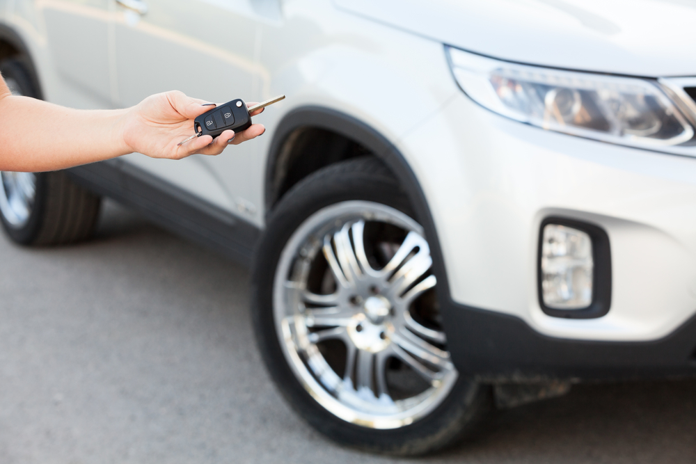 Hand Holding Car Key With SUV — Auto Body Repairs in Port Stephens, NSW